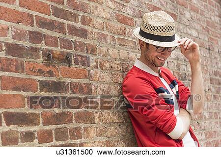 Portrait of mid adult man in front of brick wall View Large Photo Image Stock Image - Portrait of mid adult man in front of brick wall. Fotosearch