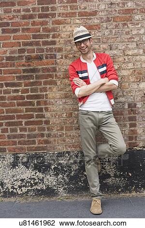 Portrait of mid adult man in front of brick wall View Large Photo Image Stock Image - Portrait of mid adult man in front of brick wall. Fotosearch