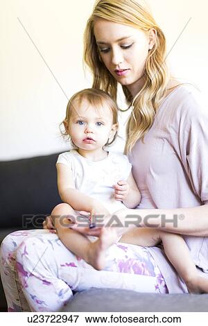 Portrait of mom and her baby girl (12-17 months) View Large Photo Image Stock Photo - Portrait of mom and her baby girl (12-17 months). Fotosearch