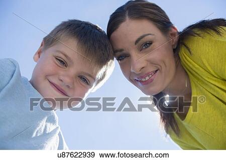 Stock Photo - Portrait of mother and son (6-7) outdoors. Fotosearch