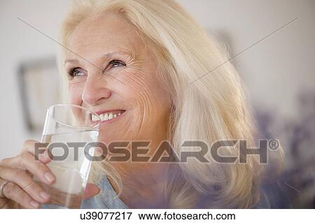 Portrait of senior woman drinking water View Large Photo Image Stock Photo - Portrait of senior woman drinking water. Fotosearch