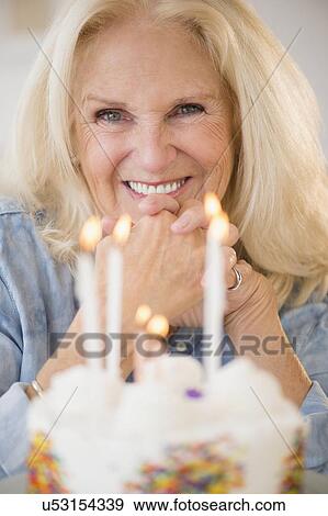 Portrait of senior woman with birthday cake View Large Photo Image Stock Photo - Portrait of senior woman with birthday cake. Fotosearch