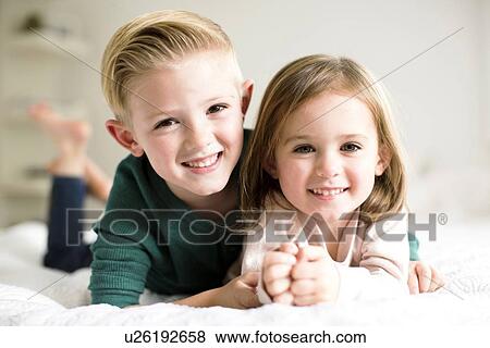 "Portrait of siblings (2-3, 4-5) lying on bed" View Large Photo Image Stock Photo - "Portrait of siblings (2-3, 4-5) lying on bed". Fotosearch