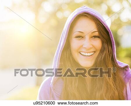 Portrait of smiling woman in hoodie View Large Photo Image Stock Image - Portrait of smiling woman in hoodie. Fotosearch