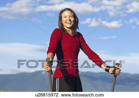 Portrait of smiling woman with trekking poles View Large Photo Image Stock Image - Portrait of smiling woman with trekking poles. Fotosearch