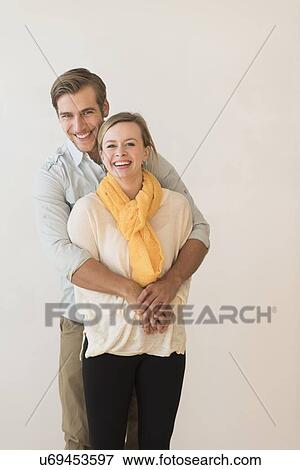 Stock Photo - Portrait of smiling young couple. Fotosearch
