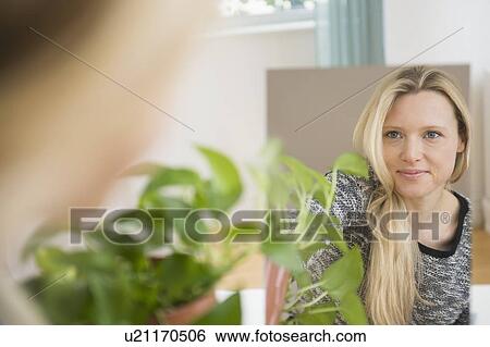 Stock Photograph - Portrait of woman reflecting in mirror. Fotosearch