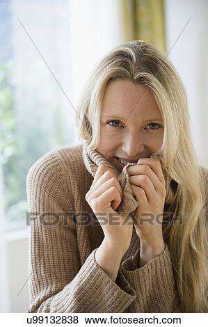 Stock Photo - Portrait of woman wearing sweater. Fotosearch