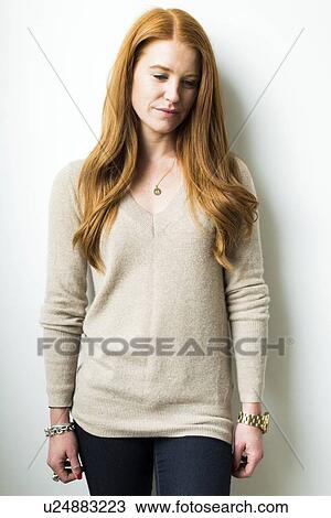 Stock Image - Portrait of woman with long red hair. Fotosearch