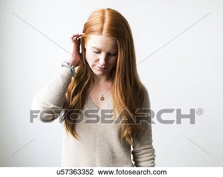 Stock Image - Portrait of woman with long red hair. Fotosearch