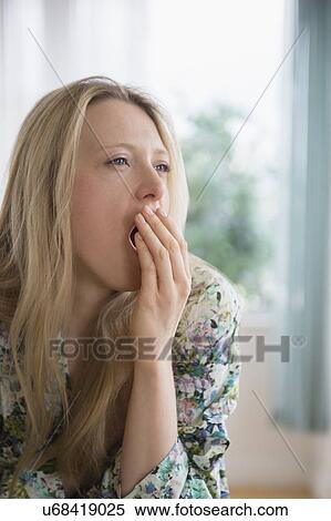Stock Photography - Portrait of woman yawning. Fotosearch