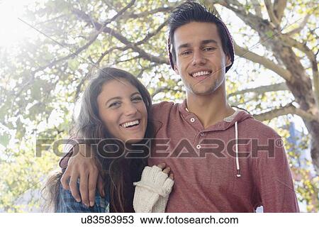 Stock Image - Portrait of young couple outdoors. Fotosearch