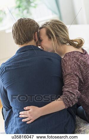 Rear view of young couple hugging View Large Photo Image Stock Photo - Rear view of young couple hugging. Fotosearch