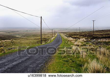 Rural country road runs through barren countryside View Large Photo Image Stock Photo - Rural country road runs through barren countryside. Fotosearch