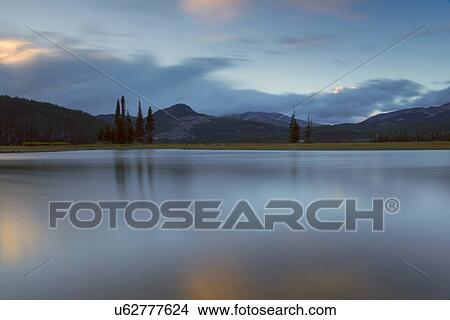 Picture - Scenic view of lake and hills at dawn. Fotosearch