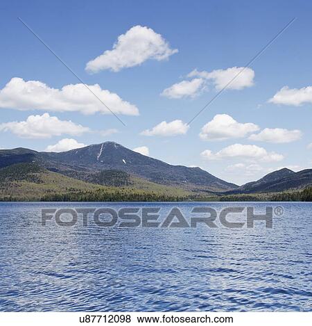 Stock Photo - Scenic view of lake and mountain. Fotosearch