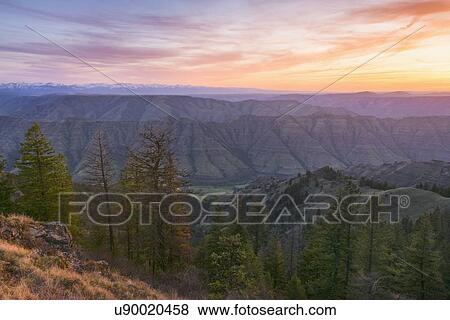 Scenic view of landscape at sunset View Large Photo Image Stock Photo - Scenic view of landscape at sunset. Fotosearch