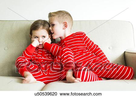 "Siblings (2-3, 4-5) in red pajamas whispering" View Large Photo Image Stock Image - "Siblings (2-3, 4-5) in red pajamas whispering". Fotosearch