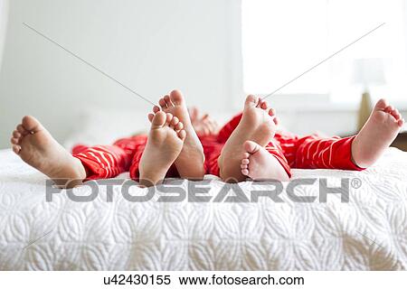 "Siblings (2-3, 4-5) in red pajamas lying on bed" View Large Photo Image Stock Photography - "Siblings (2-3, 4-5) in red pajamas lying on bed". Fotosearch