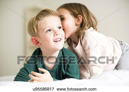 "Siblings (2-3, 4-5) whispering in bedroom" View Large Photo Image Stock Photo - "Siblings (2-3, 4-5) whispering in bedroom". Fotosearch