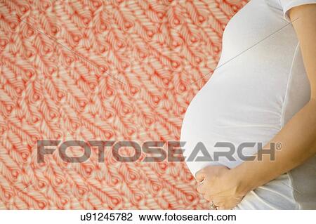 Stock Image - Side-view of pregnant woman. Fotosearch