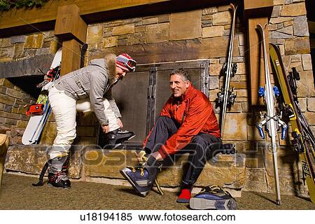 Skier putting on ski boots View Large Photo Image Stock Photography - Skier putting on ski boots. Fotosearch