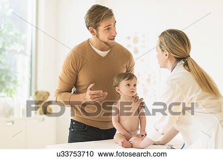 Small boy (2-3) with his father and female doctor in doctor's office View Large Photo Image Stock Image - Small boy (2-3) with his father and female doctor in doctor's office. Fotosearch