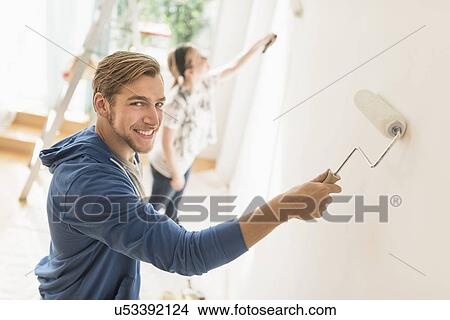 Picture - Smiling couple painting wall. Fotosearch
