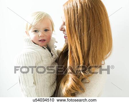 Smiling mother holding son (2-3) View Large Photo Image Stock Image - Smiling mother holding son (2-3). Fotosearch