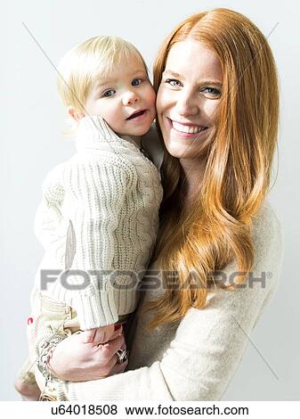 Smiling mother holding son (2-3) View Large Photo Image Stock Photo - Smiling mother holding son (2-3). Fotosearch