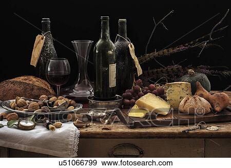 "Still life with wine bottles, selection of cheese, bread and nuts on wooden table, studio shot" View Large Photo Image Stock Photo - "Still life with wine bottles, selection of cheese, bread and nuts on wooden table, studio shot". Fotosearch