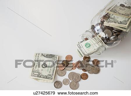 Studio Shot of banknotes and coins in jar View Large Photo Image Stock Photo - Studio Shot of banknotes and coins in jar. Fotosearch