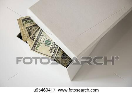 Stock Photo - Studio Shot of banknotes in box. Fotosearch