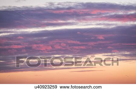 Stock Photo - Sunrise sky with clouds. Fotosearch