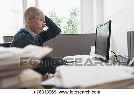 Surprised mature businessman looking at computer monitor View Large Photo Image Stock Photography - Surprised mature businessman looking at computer monitor . Fotosearch