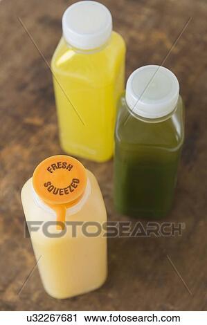 "Three bottles with fresh juice" View Large Photo Image Stock Image - "Three bottles with fresh juice". Fotosearch