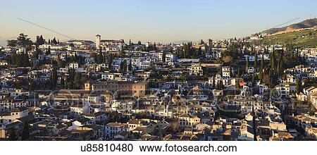 Stock Image - Townscape and hill in sunlight. Fotosearch
