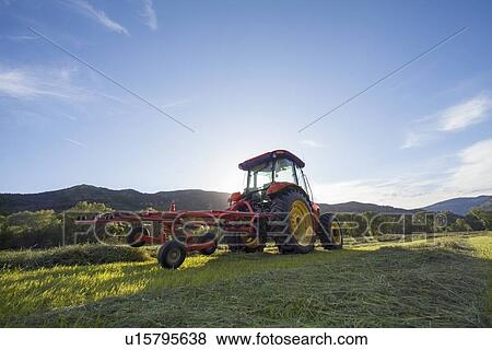 Tractor in field at sunset View Large Photo Image Stock Photo - Tractor in field at sunset. Fotosearch