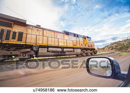 Train on railroad tracks in countryside View Large Photo Image Stock Photograph - Train on railroad tracks in countryside. Fotosearch