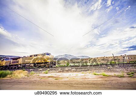 Stock Photography - Train on railroad tracks in countryside. Fotosearch