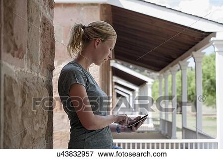 View of woman using smart phone View Large Photo Image Stock Photo - View of woman using smart phone. Fotosearch