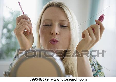 Woman applying lipgloss View Large Photo Image Stock Photo - Woman applying lipgloss. Fotosearch