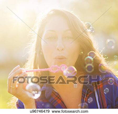 Woman blowing bubbles View Large Photo Image Stock Photo - Woman blowing bubbles. Fotosearch