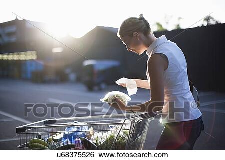 Stock Photograph - Woman checking shopping. Fotosearch