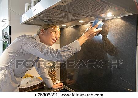 Woman cleaning kitchen View Large Photo Image Stock Image - Woman cleaning kitchen. Fotosearch