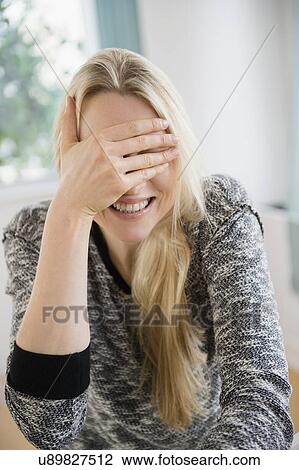 Stock Image - Woman covering her face. Fotosearch
