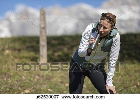 Woman drinking from bottle View Large Photo Image Stock Photo - Woman drinking from bottle. Fotosearch