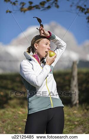 Stock Photography - Woman eating apple. Fotosearch