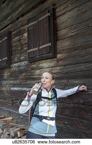 Woman hiker drinking from bottle View Large Photo Image Stock Photograph - Woman hiker drinking from bottle. Fotosearch