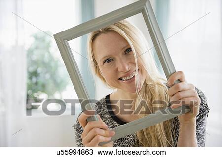 Woman holding picture frame View Large Photo Image Stock Image - Woman holding picture frame. Fotosearch